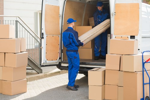 Van and moving team loading items for a booked removal service