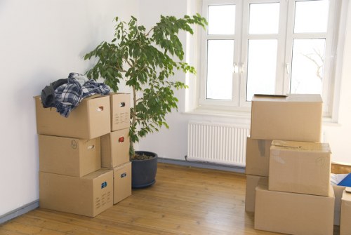 Specialist movers preparing an upright piano for transport in Barnet