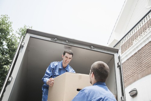 Worker using safe lifting techniques with loading equipment