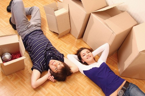Packed boxes and furniture being loaded into a removal van